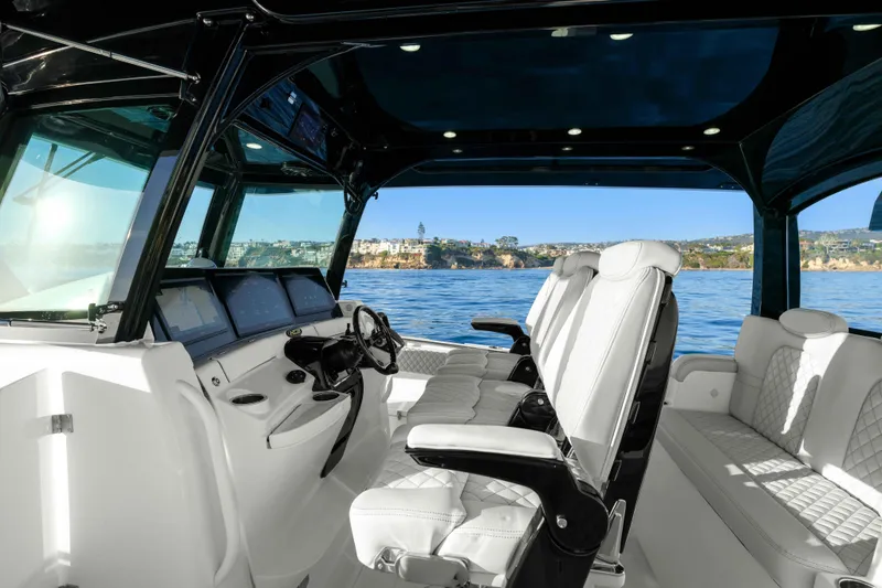 Slide: The Image of The image shows the cockpit of a 2026 HCB 42 Lujo with luxurious white seats and a modern helm. - 30