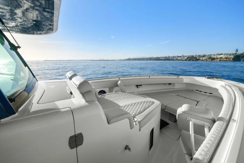 Slide: The Image of The image shows the deck of a 2026 HCB 42 Lujo boat with luxurious seating and ocean view. - 27