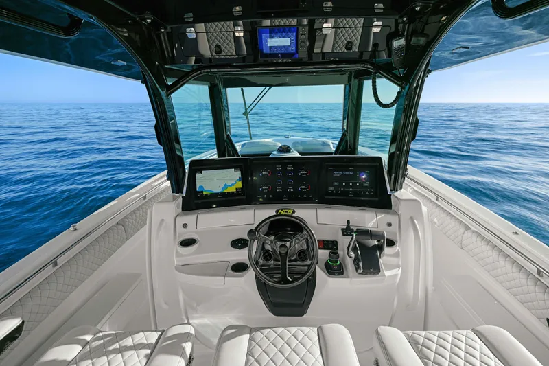 Slide: The Image of The cockpit of the 2026 HCB 42 Lujo features modern instruments and luxurious design on open water. - 20