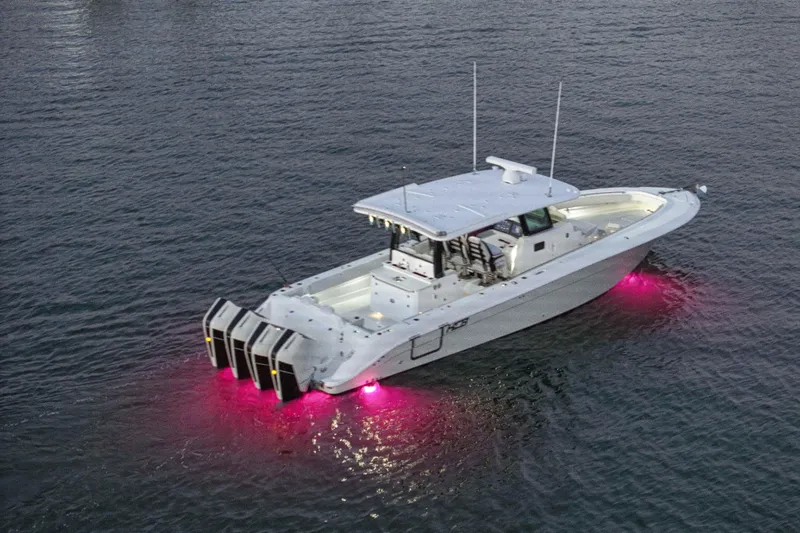 Slide: The Image of A modern motorboat with four outboard engines and pink underwater lights on calm water. - 11