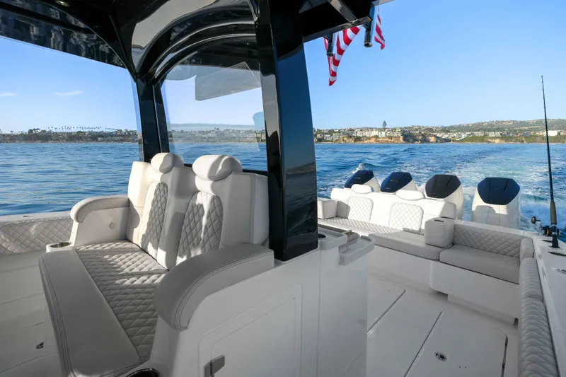 Slide: The Image of Luxurious boat with sleek seating, open deck, and American flag, on calm waters. - 33