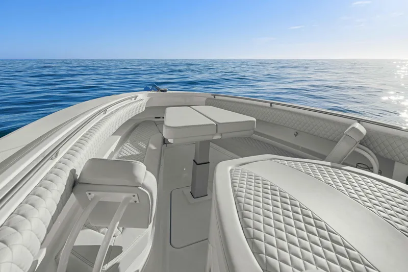 Slide: The Image of The image shows the deck of an HCB 42 Lujo boat on calm water under a blue sky. - 21