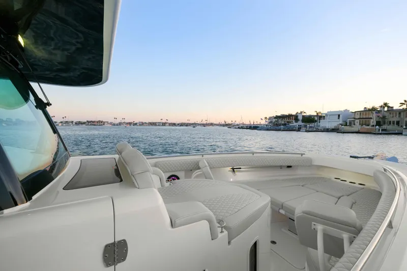 Slide: The Image of HCB 42 Lujo 2026: Luxurious boat with sleek seating, on calm waters at sunset. - 47