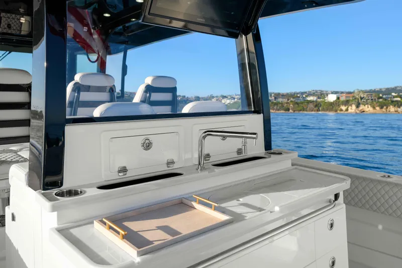 Slide: The Image of The 2026 HCB 42 Lujo features a modern outdoor kitchen with a sink and storage. - 29