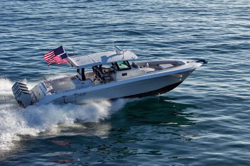 Slide: The Image of A modern motorboat speeds across the water, with an American flag at the stern. - 5