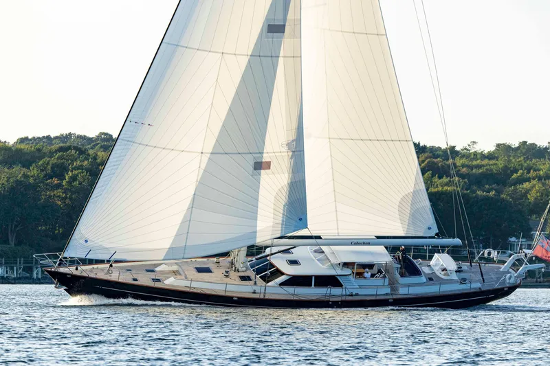 Slide: The Image of 2004 Ta Chiao Custom Pilothouse Cutter sailing on calm waters, lush greenery in background. - 59