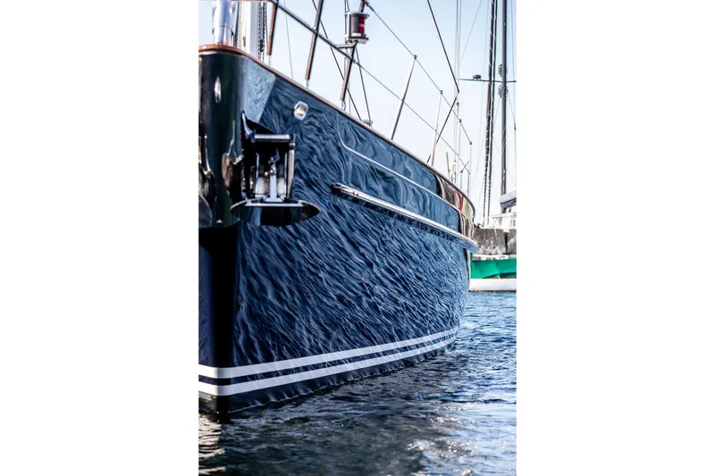 Slide: The Image of 2004 Ta Chiao Custom Pilothouse Cutter yacht on water, showcasing sleek hull design. - 56