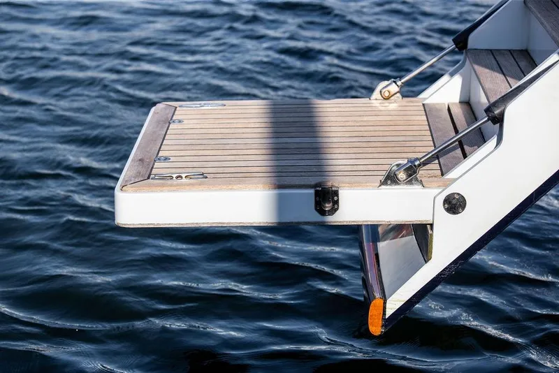 Slide: The Image of Ta Chiao 2004 Custom Pilothouse Cutter swim platform over water. - 18
