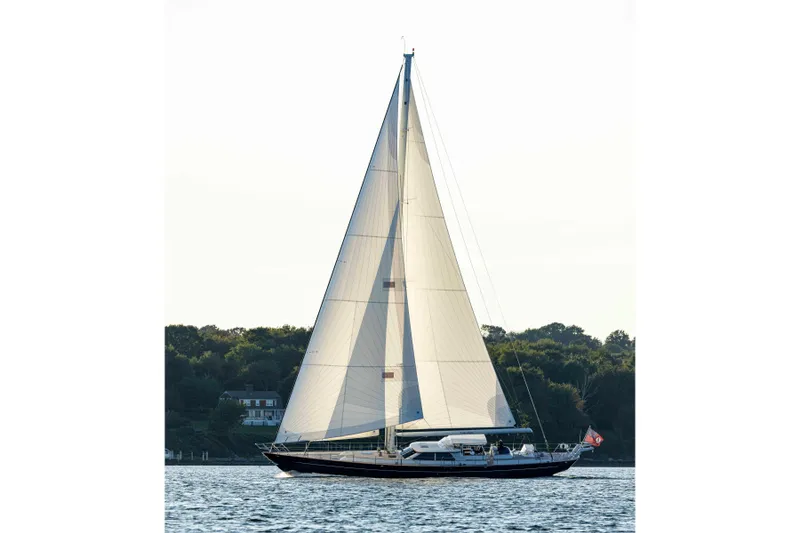 Slide: The Image of 2004 Ta Chiao Custom Pilothouse Cutter sailing on calm waters near a wooded shoreline. - 62