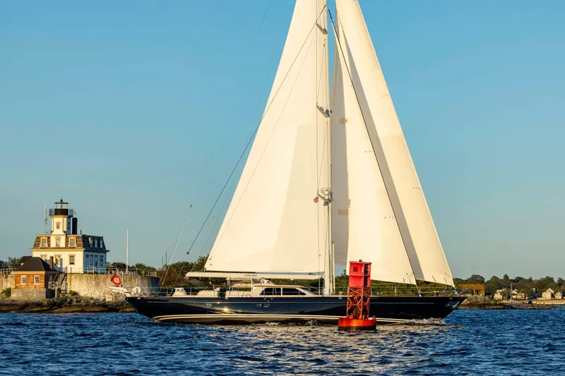 Slide: The Image of Sailing yacht Ta Chiao Custom Pilothouse Cutter 2004 near a lighthouse on a sunny day. - 58