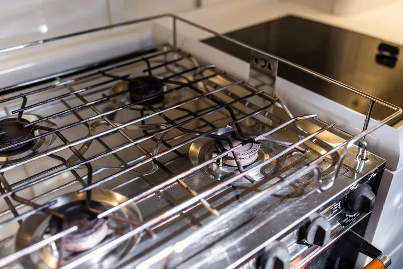 Slide: The Image of Stainless steel stove with three burners on a 2004 Ta Chiao Custom Pilothouse Cutter. - 52