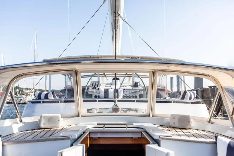 Slide: The Image of 2004 Ta Chiao Custom Pilothouse Cutter yacht with elegant deck and striped cushions. - 5