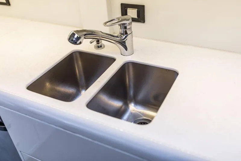 Slide: The Image of Stainless steel double sink with modern faucet on Ta Chiao Custom Pilothouse Cutter, 2004. - 49