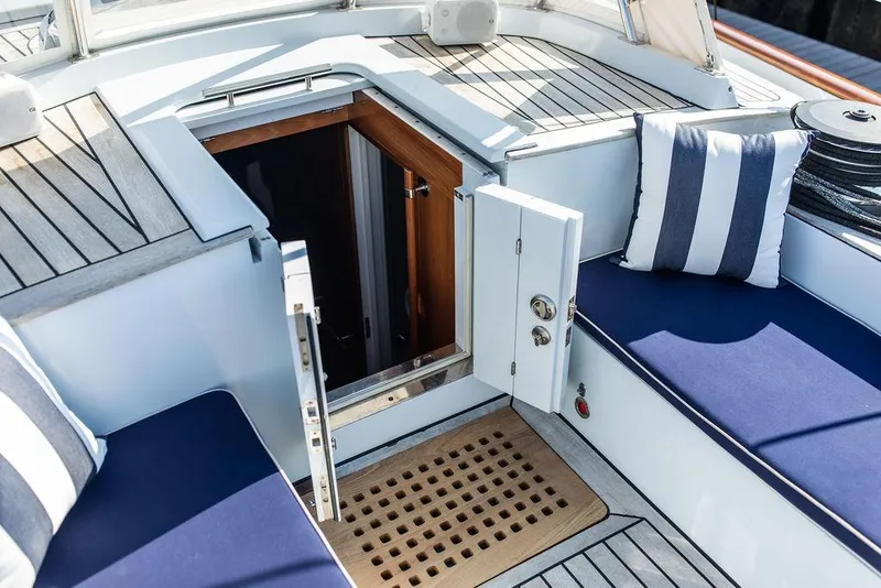 Slide: The Image of 2004 Ta Chiao Custom Pilothouse Cutter cockpit with open hatch and striped cushions. - 7