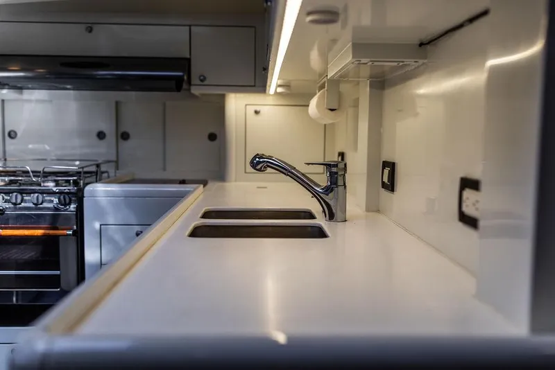 Slide: The Image of Modern kitchen in 2004 Ta Chiao Custom Pilothouse Cutter with sleek countertops and appliances. - 48