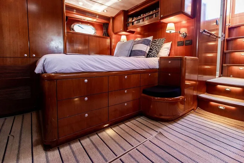 Slide: The Image of Luxurious 2004 Ta Chiao Custom Pilothouse Cutter bedroom with wooden cabinetry and cozy bedding. - 34