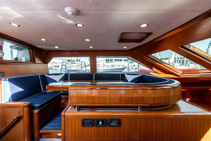 Slide: The Image of Luxurious 2004 Ta Chiao Custom Pilothouse Cutter interior with elegant wood finish and plush seating. - 22