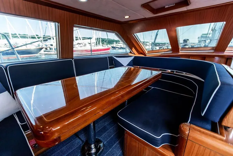 Slide: The Image of Luxurious interior of 2004 Ta Chiao Custom Pilothouse Cutter with polished wood table and plush seating. - 24