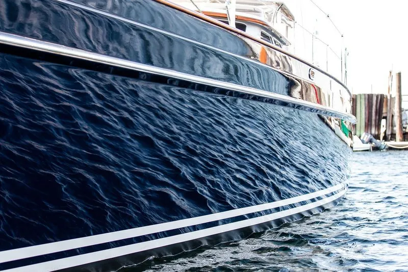 Slide: The Image of 2004 Ta Chiao Custom Pilothouse Cutter with sleek blue hull on water. - 15