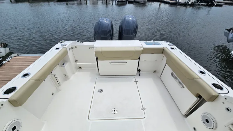 Slide: The Image of The image shows the cockpit of a 2021 Pursuit DC 266 Dual Console boat with twin engines. - 22