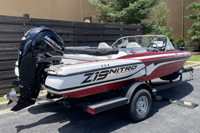 Slide: The Image of 2021 Nitro Z19 Sport boat with Mercury engine on trailer, parked outdoors. - 6