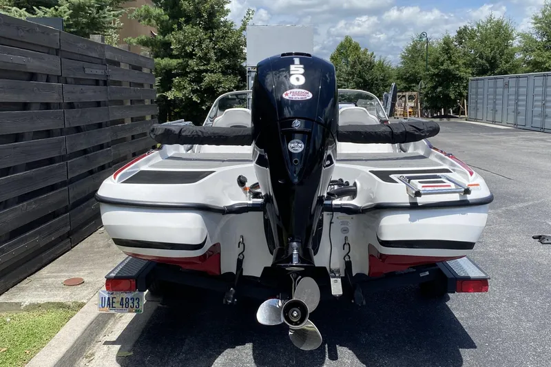Slide: The Image of 2021 Nitro Z19 Sport boat with powerful outboard motor, parked outdoors. - 5