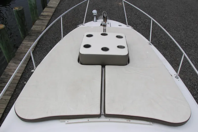 Slide: The Image of 2002 Sea Ray Sundancer 260 boat deck with cushioned seating and cup holders. - 11