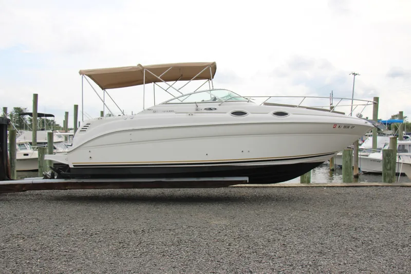Slide: The Image of 2002 Sea Ray Sundancer 260 boat docked at marina with canopy. - 4
