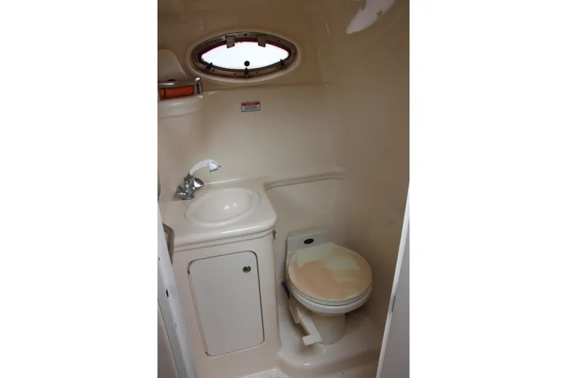 Slide: The Image of Compact bathroom in 2002 Sea Ray Sundancer 260 boat, featuring sink and toilet. - 8