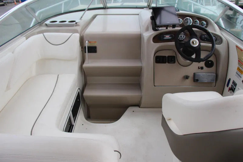 Slide: The Image of 2002 Sea Ray Sundancer 260 cockpit with steering wheel, seating, and control panel. - 6