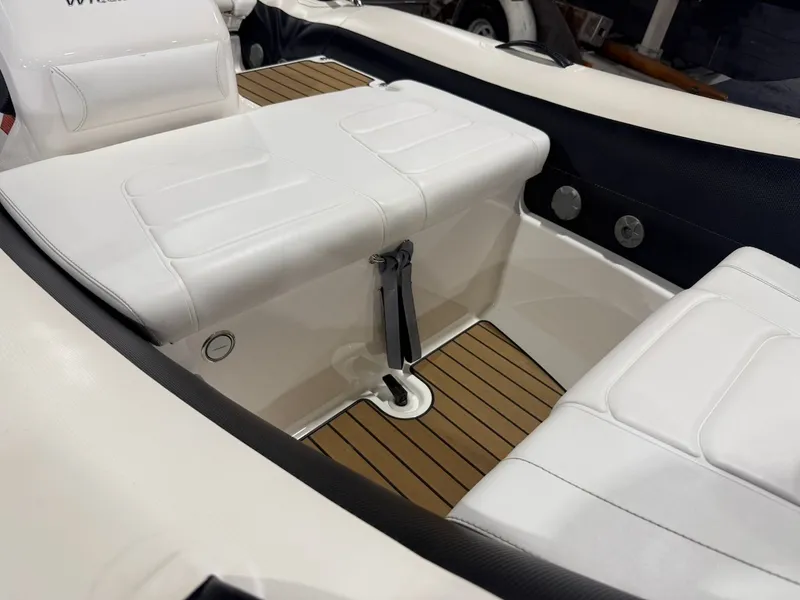 Slide: The Image of Interior view of a 2019 Williams Jet Tenders 395 Sport Jet with white seats and wood flooring. - 8