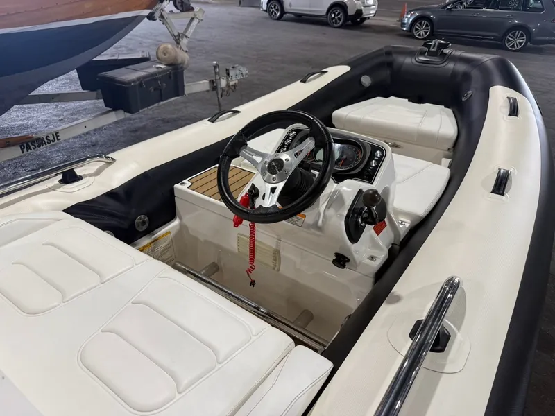 Slide: The Image of A 2019 Williams Jet Tenders 395 Sport Jet with white interior and black steering wheel. - 10
