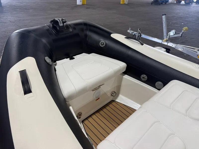 Slide: The Image of The image shows the interior of a 2019 Williams Jet Tenders 395 Sport Jet with white seating. - 2