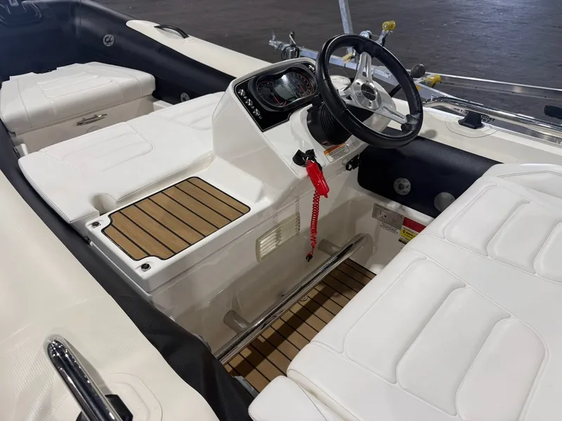 Slide: The Image of The image shows the cockpit of a 2019 Williams Jet Tenders 395 Sport Jet with white seating and a black steering wheel. - 3
