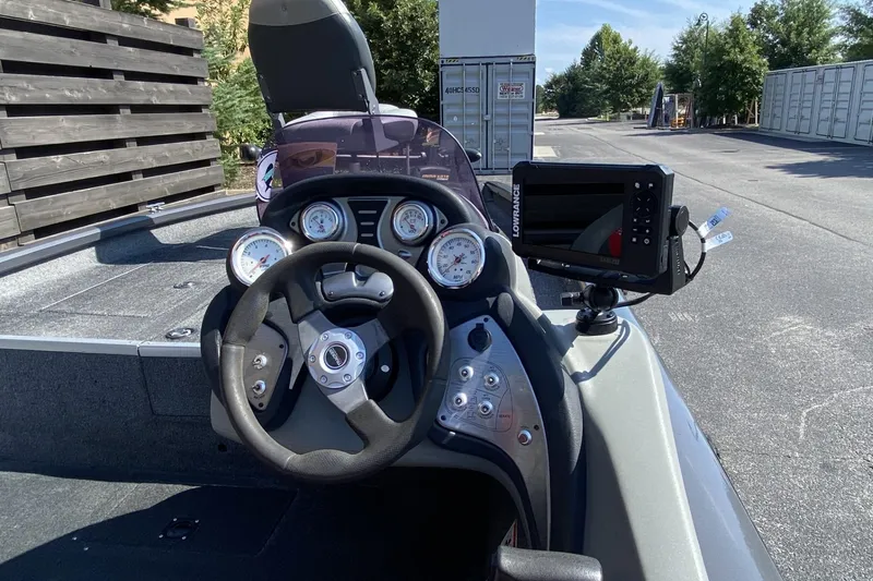 Slide: The Image of 2014 Tracker Pro Team 190 TX boat dashboard with steering wheel and gauges. - 3