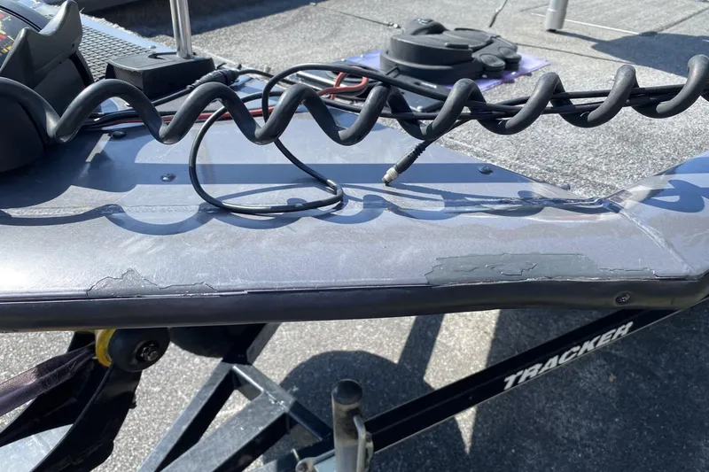 Slide: The Image of 2014 Tracker Pro Team 190 TX boat with visible wear and coiled cable on deck. - 11
