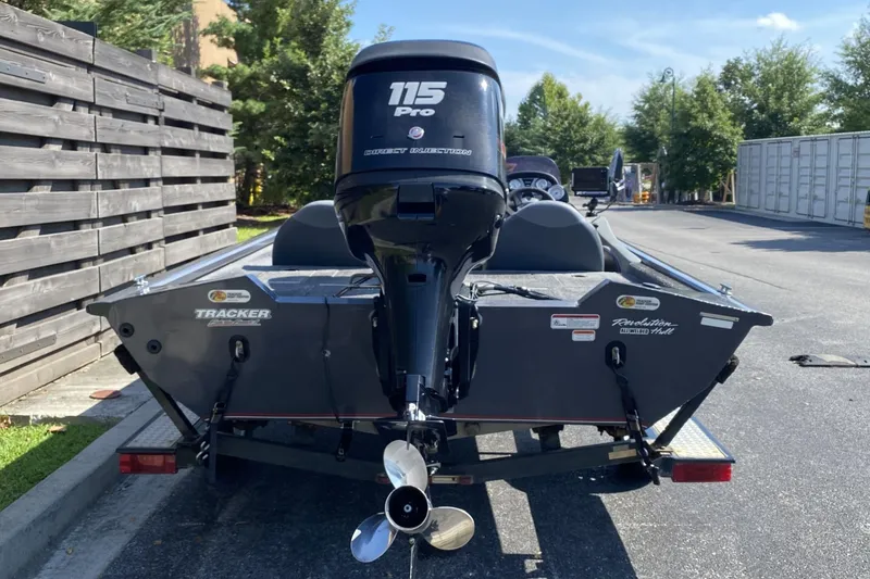 Slide: The Image of 2014 Tracker Pro Team 190 TX boat with 115 Pro outboard motor, parked outdoors. - 6