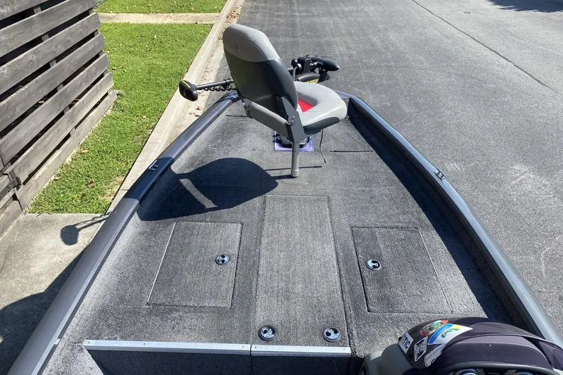 Slide: The Image of 2014 Tracker Pro Team 190 TX boat with seating and storage compartments. - 10