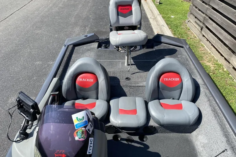 Slide: The Image of 2014 Tracker Pro Team 190 TX boat interior with gray and red seating. - 4
