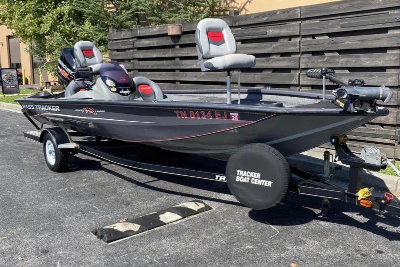 Slide: The Image of 2014 Tracker Pro Team 190 TX bass boat on trailer, parked outdoors. - 8