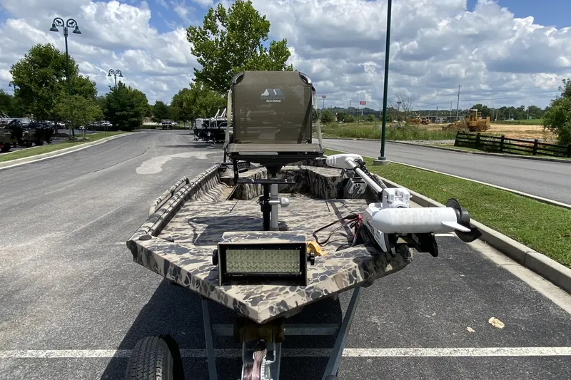 Slide: The Image of 2022 Havoc 1860 DBST boat with camouflage design, parked outdoors under a cloudy sky. - 4