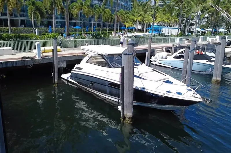 Slide: The Image of 2015 Regal 35 Sport Coupe docked at marina with palm trees in background. - 10