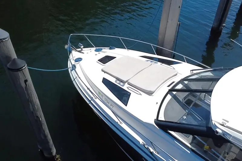 Slide: The Image of 2015 Regal 35 Sport Coupe yacht docked, featuring sleek design and spacious deck. - 4
