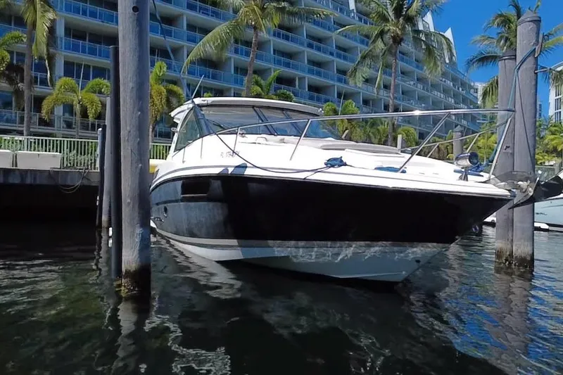 Slide: The Image of 2015 Regal 35 Sport Coupe docked near waterfront buildings and palm trees. - 12