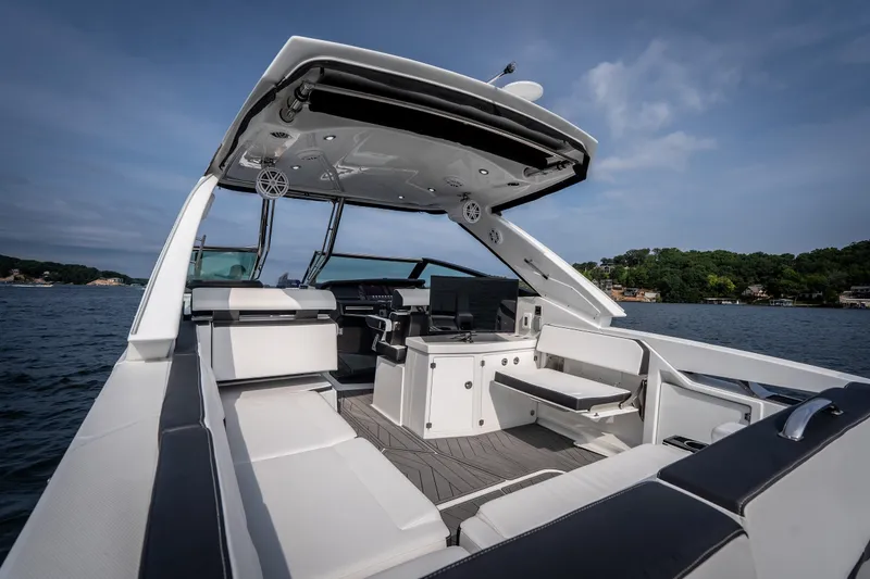 Slide: The Image of 2023 Monterey 378SS Super Sport boat interior with sleek seating and modern design on a lake. - 9