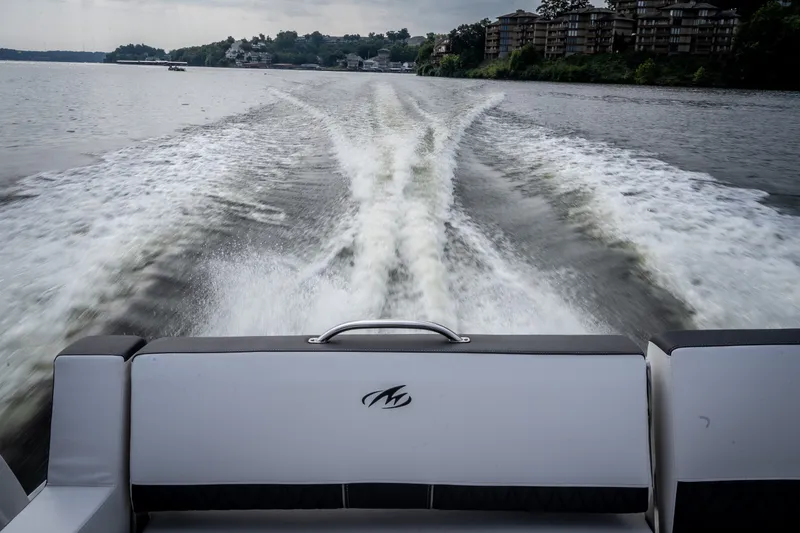 Slide: The Image of 2023 Monterey 378SS Super Sport boat cruising on a scenic lake. - 46
