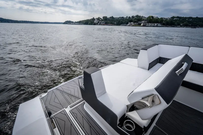Slide: The Image of 2023 Monterey 378SS Super Sport boat on a serene lake with stylish seating. - 38