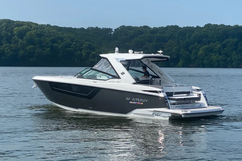 Slide: The Image of 2023 Monterey 378SS Super Sport boat cruising on a serene lake. - 7