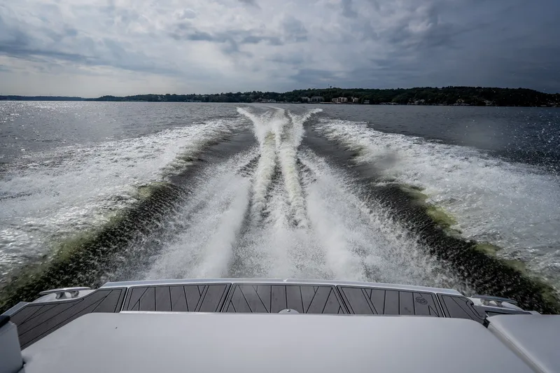 Slide: The Image of Wake trail behind 2023 Monterey 378SS Super Sport boat on a cloudy day. - 48