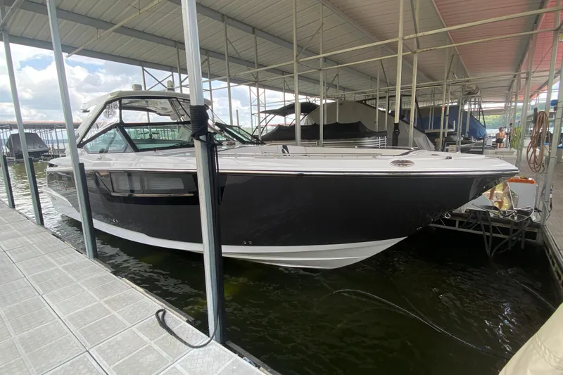 Slide: The Image of 2023 Monterey 378SS Super Sport boat docked under covered marina. - 12